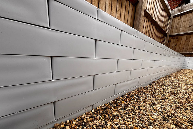 Retaining wall built from recycled plastic modular building blocks