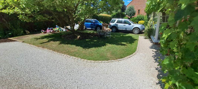 Driveway with stones held by honeycomb gravel grids