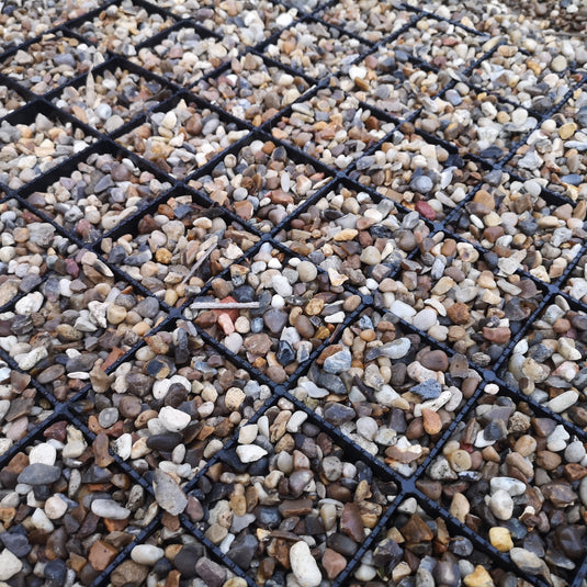 ground reinforcement mat with gravel driveway surface