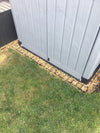 Plastic shed sitting on top of recycled plastic shed base grids