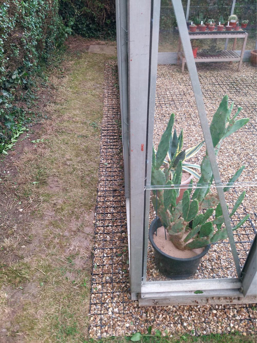 Plastic greenhouse base grids with gravel fill